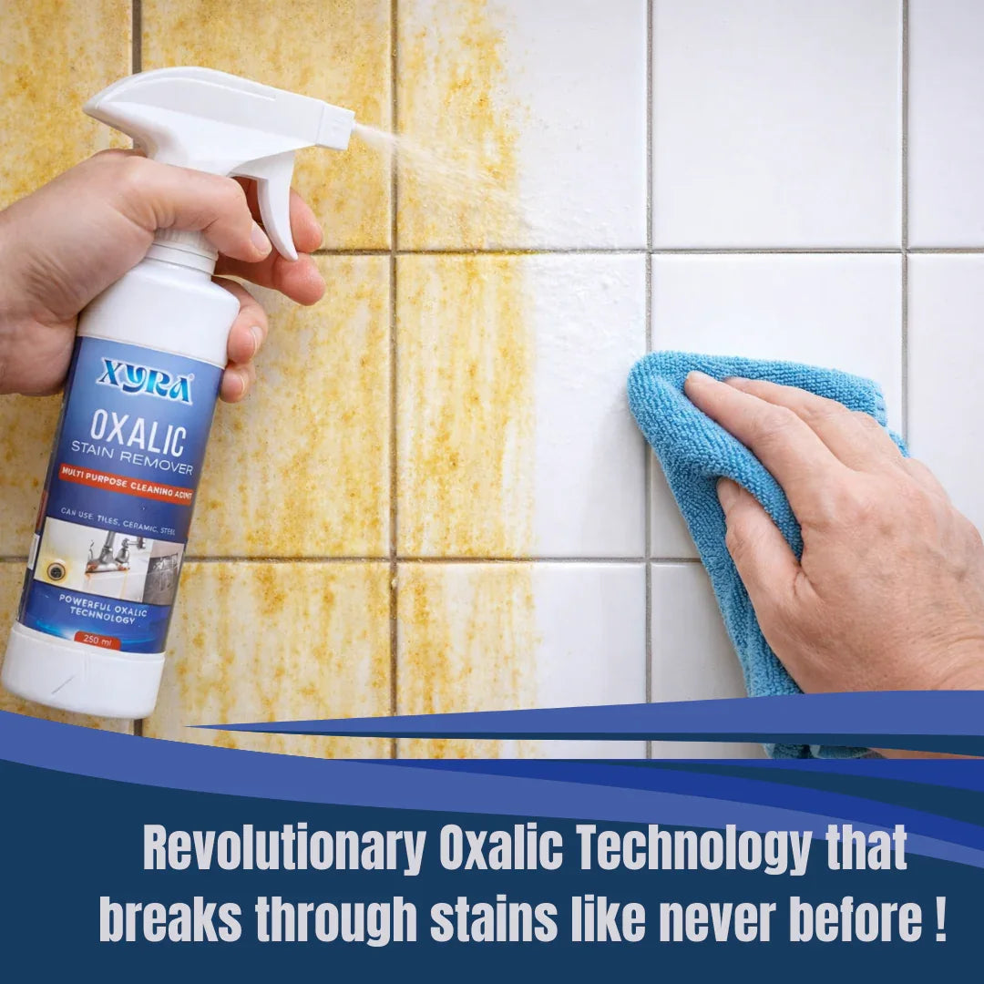 Multipurpose stain remover spray being used to clean yellow stains from tiled wall with microfiber cloth.