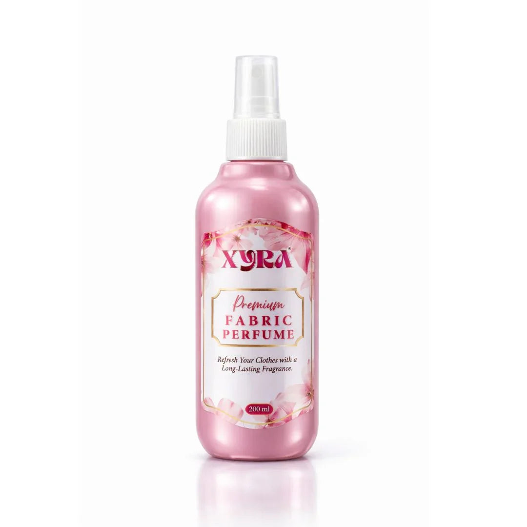 Pink fabric perfume spray bottle with floral design on white background