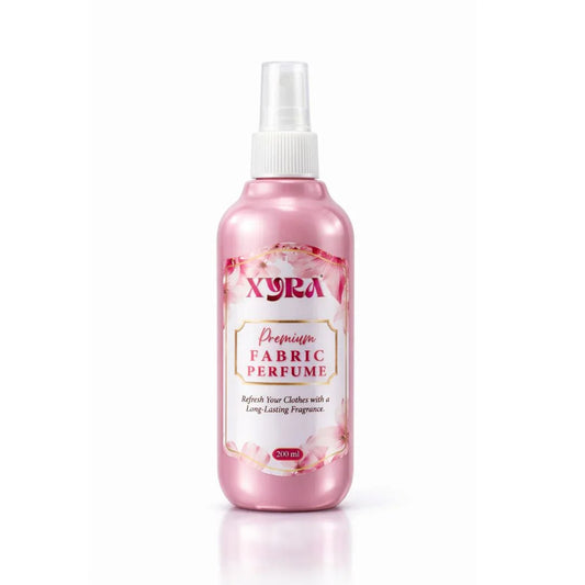 Pink fabric perfume spray bottle with floral design on white background
